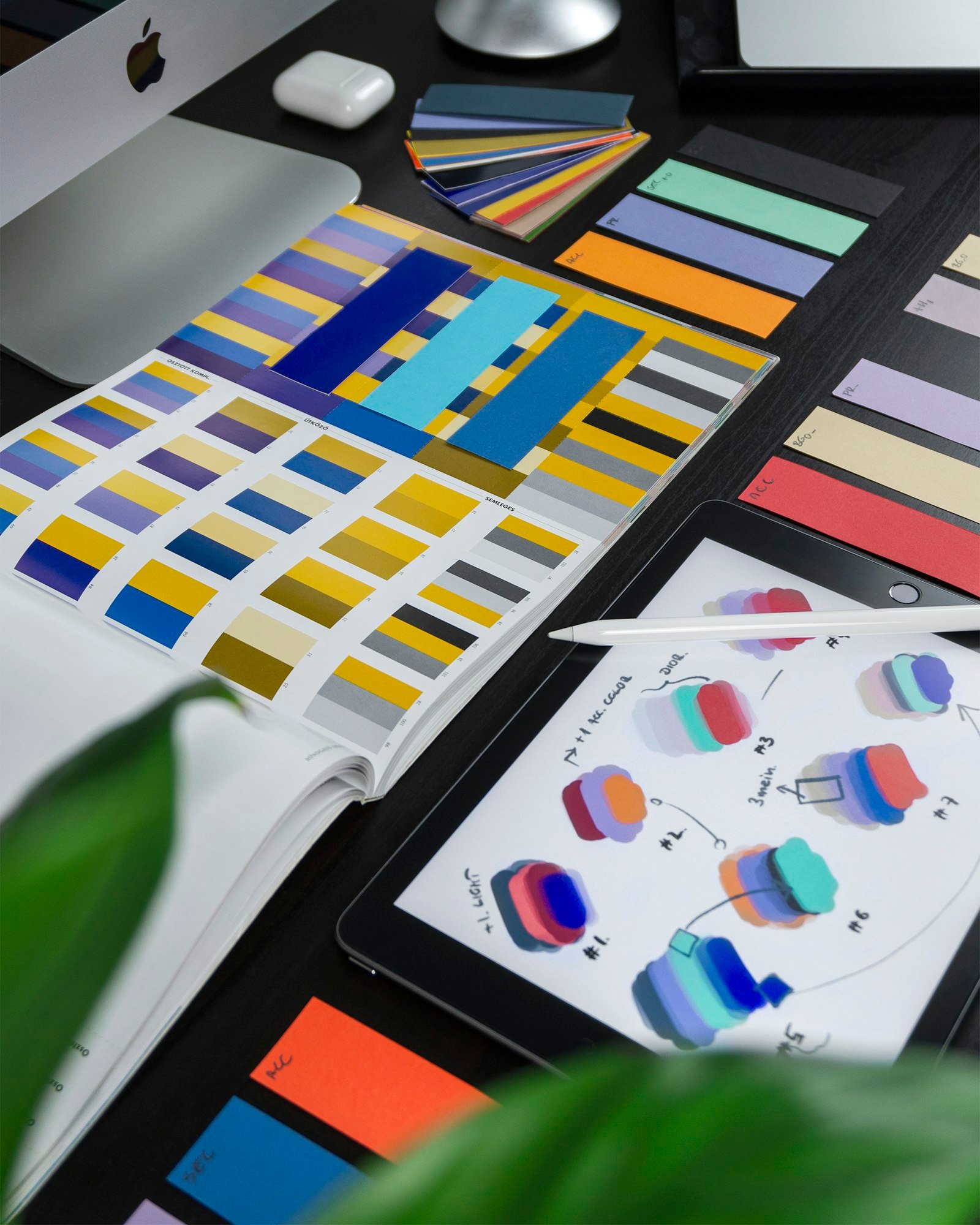 Graphic designer workspace with colour swatches and a stylus